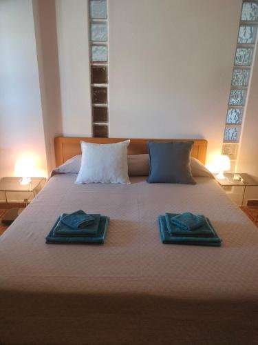 two towels on a bed with two pillows on it at Bougainville Bianco in Quartu SantʼElena