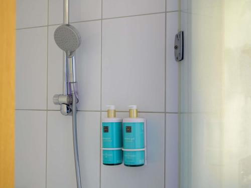 a bathroom with two bottles of water and a shower at Novotel Aachen City in Aachen