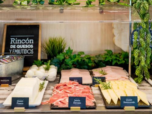 a display of different types of cheese and meats at Ibis Madrid Getafe in Getafe