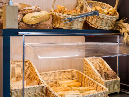 a closet with baskets of bread and baskets of pastries at Ibis Madrid Getafe in Getafe
