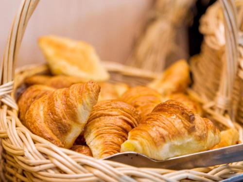 a basket filled with croissants and other bread at Ibis Madrid Getafe in Getafe