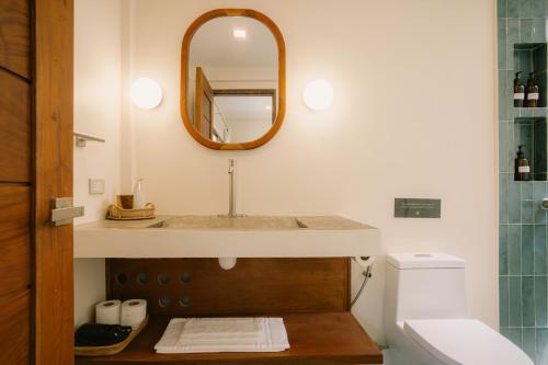 a bathroom with a sink and a mirror at Ananda House in El Nido