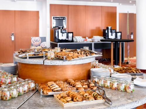 a buffet with many different types of donuts and pastries at Mövenpick Hotel Budapest Centre in Budapest