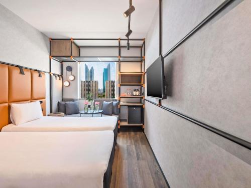 a hotel room with two beds and a window at Ibis World Trade Centre in Dubai
