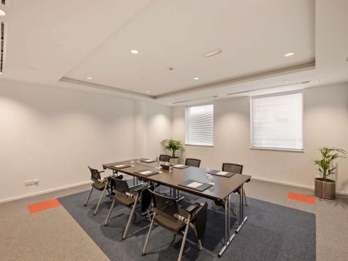 a conference room with a large table and chairs at Ibis World Trade Centre in Dubai