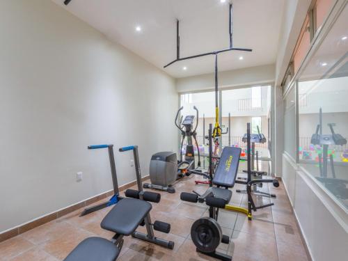 a gym with several exercise equipment in a room at Oaxaca Guest Hotel in Oaxaca City