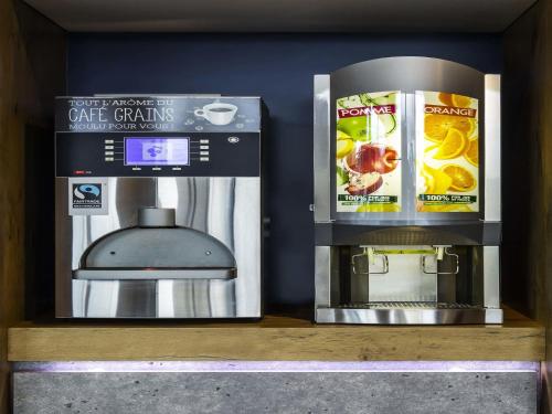 a coffee maker and a coffee machine on a shelf at ibis Budget Luxembourg Aeroport in Luxembourg