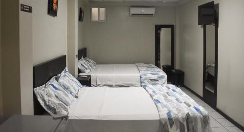 a hospital room with two beds in it at Hotel Paris in Machala