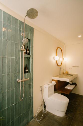 a bathroom with a toilet and a sink at Ananda House in El Nido