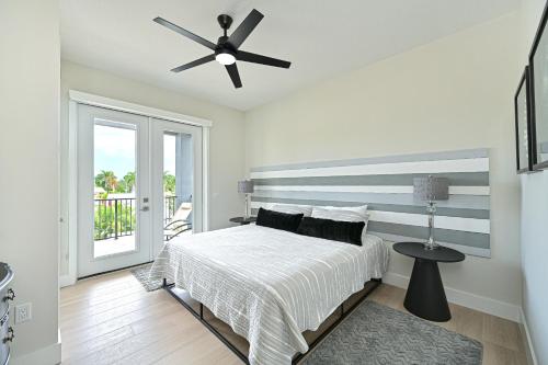 a bedroom with a bed and a ceiling fan at Entire Siesta Key Beach House - 6 BR, Pool & Ocean Access in Siesta Key
