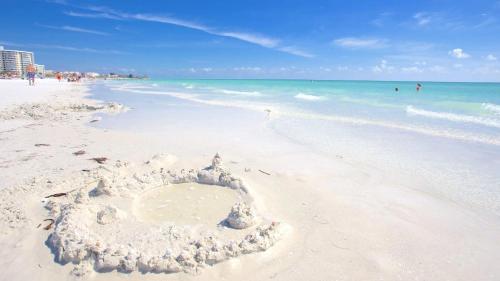 a sand castle on a beach with the ocean at Entire Siesta Key Beach House - 6 BR, Pool & Ocean Access in Siesta Key
