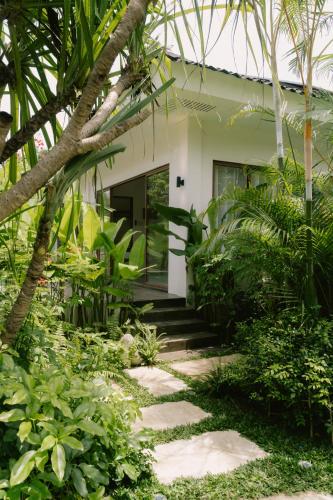 a walkway leading to the front of a house at Ananda House in El Nido