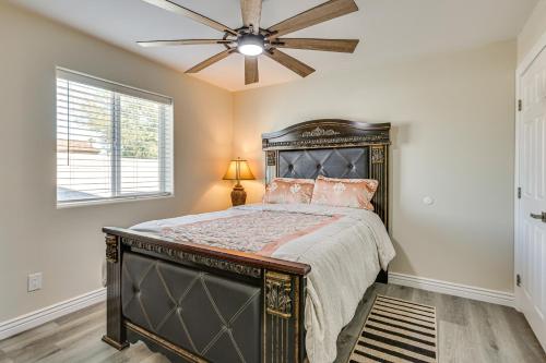 a bedroom with a large bed with a ceiling fan at 3 Mi to Desert Diamond Arena Peoria Home with Yard! in Shamrock Mobile Home Park