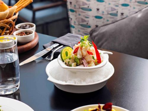 a bowl of food sitting on top of a table at Novotel Bahrain Al Dana Resort in Manama