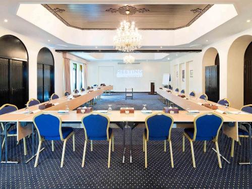a large meeting room with a long table and chairs at Novotel Bahrain Al Dana Resort in Manama