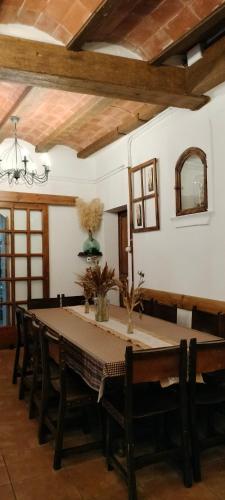 a dining room with a long table and chairs at Cal Belló Casa rural in Lleida