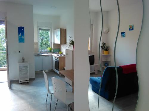 a kitchen and a living room with a table and chairs at Apartment Julie 4 in Rijeka