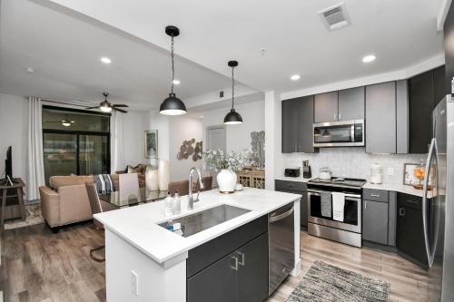 a kitchen with a sink and a counter top at Haus of Blues-HighRise-NRG Stadium-Med Center- Private Parking in Houston