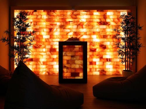 a mirror in front of a brick wall with lights at Mercure Bergamo Centro Palazzo Dolci in Bergamo