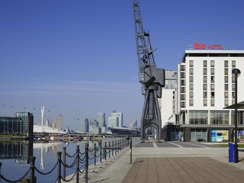 a building with a crane next to a body of water at ibis London Excel-Docklands in London