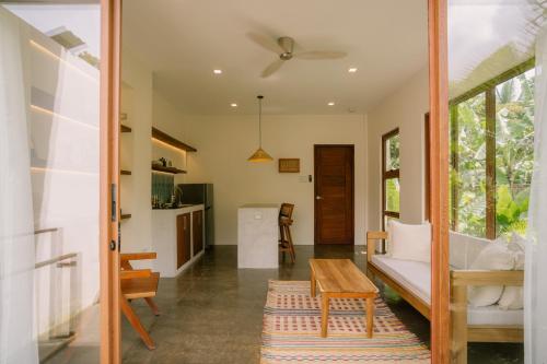 a living room with a couch and a table at Ananda House in El Nido