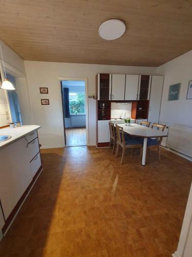 a kitchen and dining room with a table and chairs at Lovely Holiday Home With Views Of Fields in Lebøl