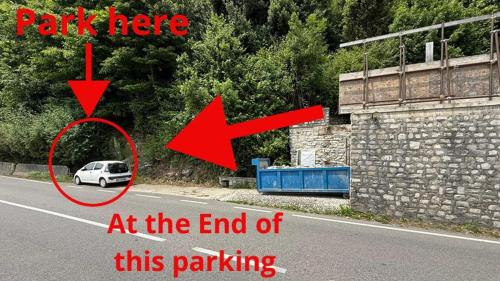 a white car parked on the side of a road at Como Lake View Enjoy&Relax in Brienno