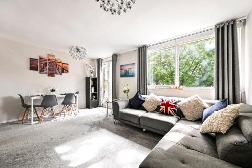 a living room with a couch and a table at Modern 3-Bed Maisonette - Epping High Street - Parking - LMV Property in Epping