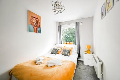 a bedroom with a large bed and a window at Modern 3-Bed Maisonette - Epping High Street - Parking - LMV Property in Epping
