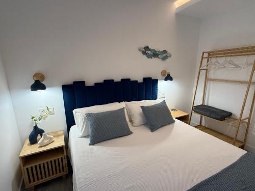 a bedroom with a large white bed with two pillows at La Casita del Mar in Combarro