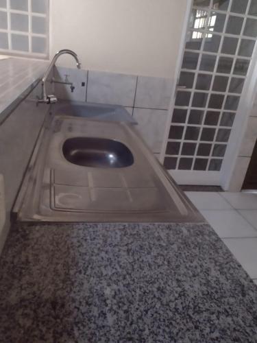 a bathroom with a sink with a faucet at Casa de temporada lus delicatte in Olímpia