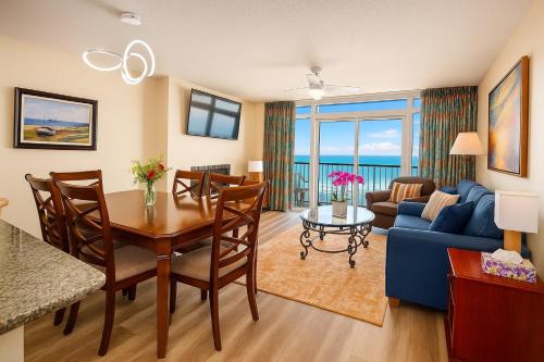 a living room with a table and a blue couch at Atlantica Resort in Myrtle Beach