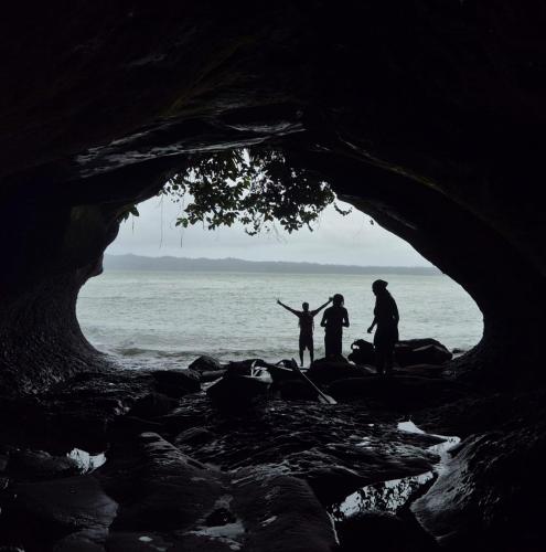 a group of three people standing in a cave at SURF HOUSE ESTILO LIBRE in Buenaventura