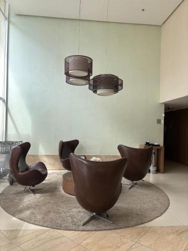 a living room with chairs and a chandelier at Linhares Design Hotel 408 in Linhares