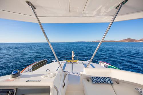 a person standing on the back of a boat on the water at Leopard 51' in La Paz
