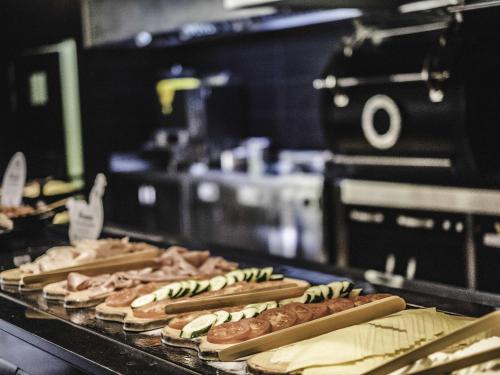 a row of hot dogs on a counter in a kitchen at Novotel Barcelona Cornellà in Cornellà de Llobregat
