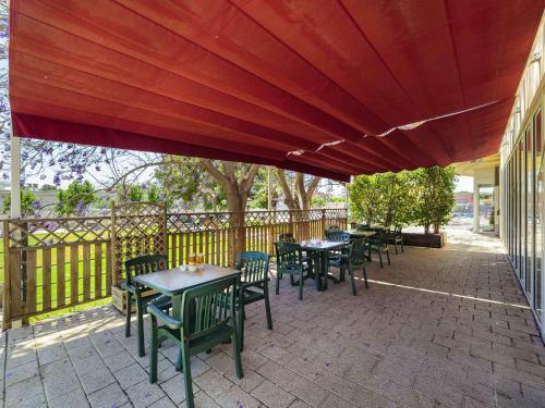 a group of tables and chairs on a patio at Ibis Murcia in Murcia