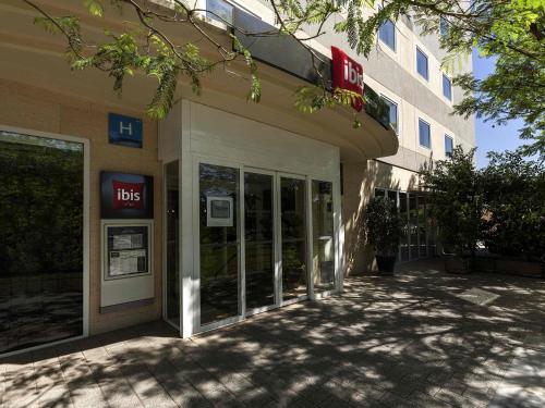a store front of a building with its doors open at Ibis Murcia in Murcia