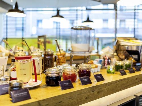 a counter with many jars of jam on it at ibis Hotel Hamburg St. Pauli Messe in Hamburg