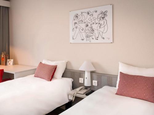 Ein Bett oder Betten in einem Zimmer der Unterkunft Ibis Valencia Alfafar
