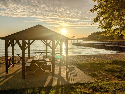 a gazebo on the shore of a lake at Dom Wczasowy Pięciu Pomostów in Czaplinek