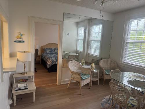 a bedroom with a bed and a table and chairs at TROPICAL Palm Beach WIFI 2BEDROOM 2BATHROOM OutdoorPOOL Beach Garden in Palm Beach