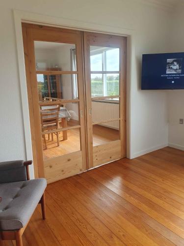 a room with a sliding glass door with a table at Lovely Holiday Home With Views Of Fields in Lebøl