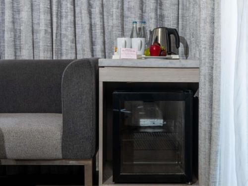 a table with a fireplace next to a couch at Mercure Kuta Bali in Kuta