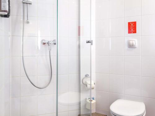 a bathroom with a shower and a toilet at Hotel Ibis Krakow Centrum in Kraków