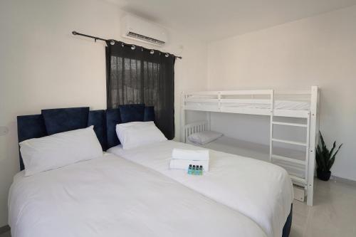 a bedroom with a bed and a bunk bed at Levication Multiple Apartments - Family Stays Tiberias in Tiberias