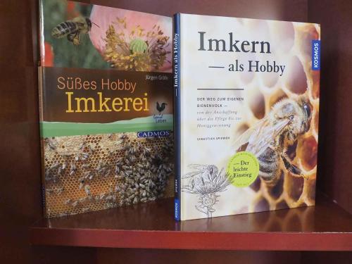 two books sitting on top of a shelf at Novotel Suites Wien City Donau in Vienna