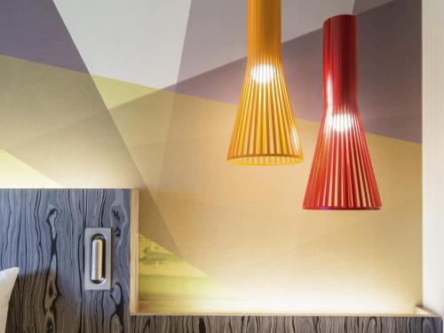three lights hanging from the ceiling of a room at Ibis Styles Ambassador Seoul Gangnam in Seoul
