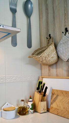 a kitchen counter with utensils and a basket on the wall at La Casa de Praves in Praves