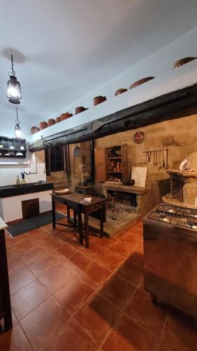 a large kitchen with a table and a stove at Casa Dos Strecht's in Castelo de Paiva